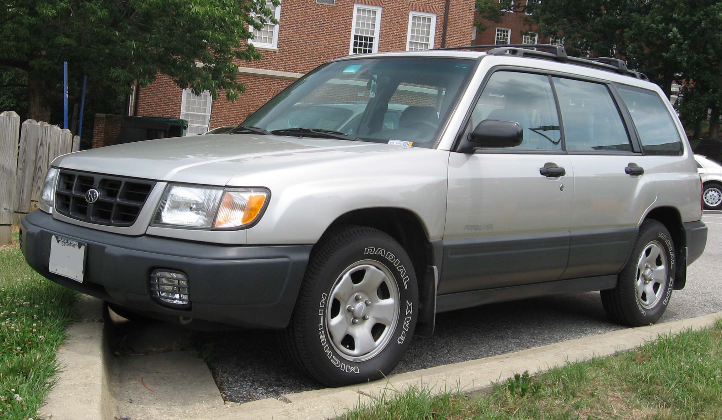 First-generation Forester (SF), silver, front 3/4 — the original "taller wagon" proto-crossover shape