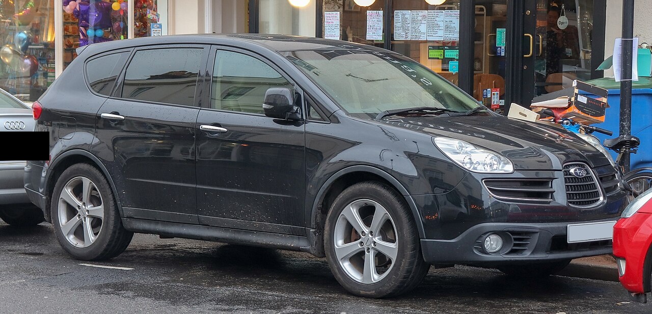 2006 Subaru B9 Tribeca, black, front 3/4, original "shark nose" grille, UK street